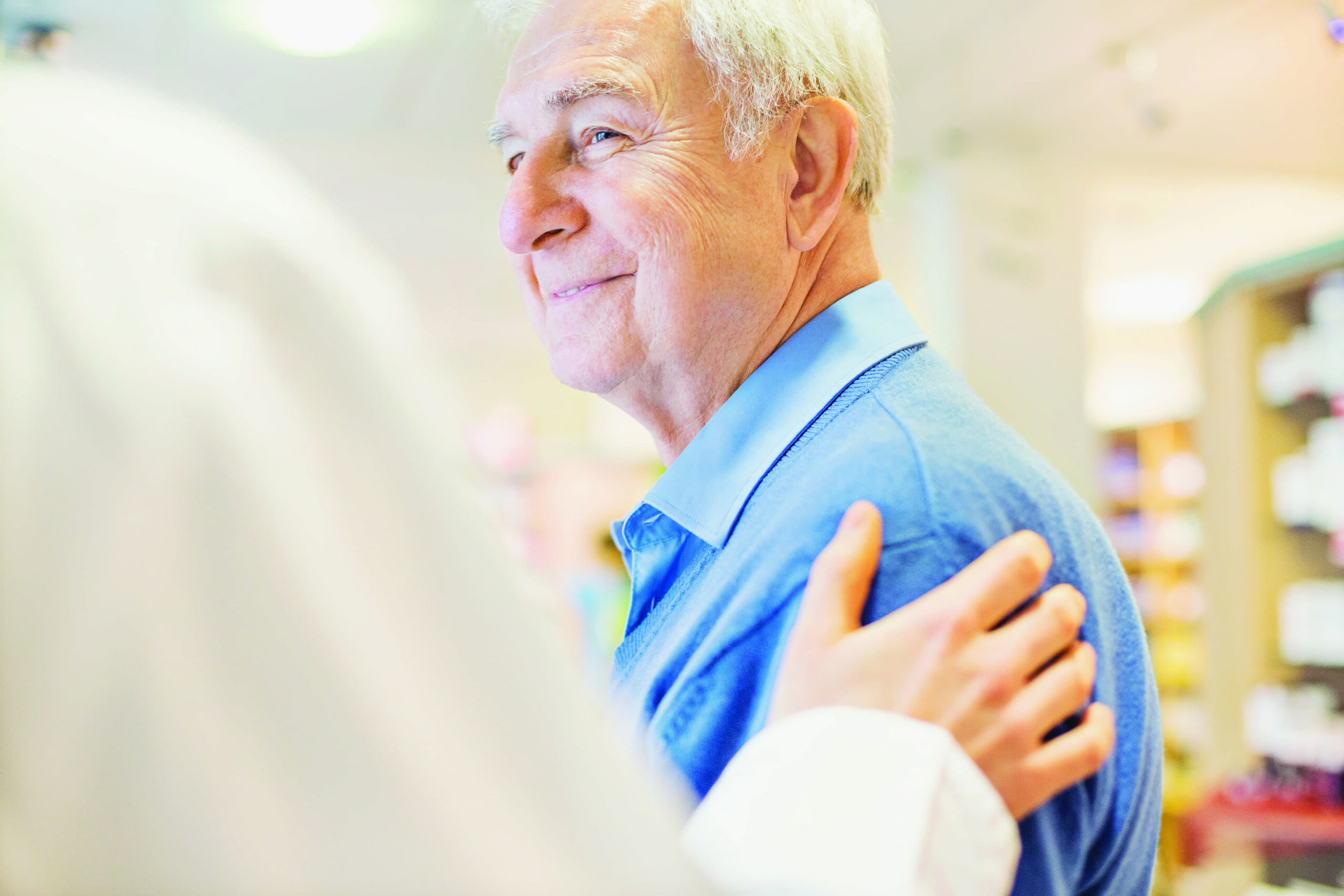 Old man being re-assured by a doctor