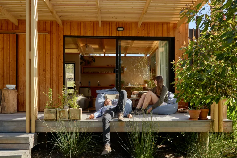 two people sitting on a seat in an airbnb on rudi road.