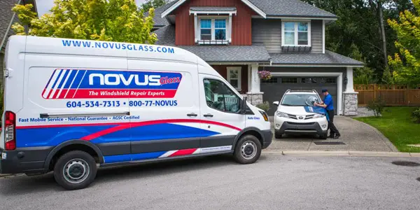 a glass repair van attending a car