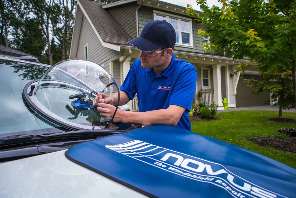 a man fixing a chipped window